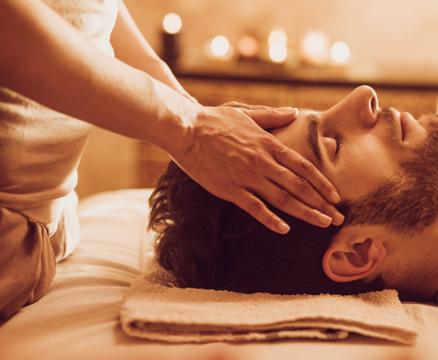 Man being given a head massage in Aura Spa Yards DC